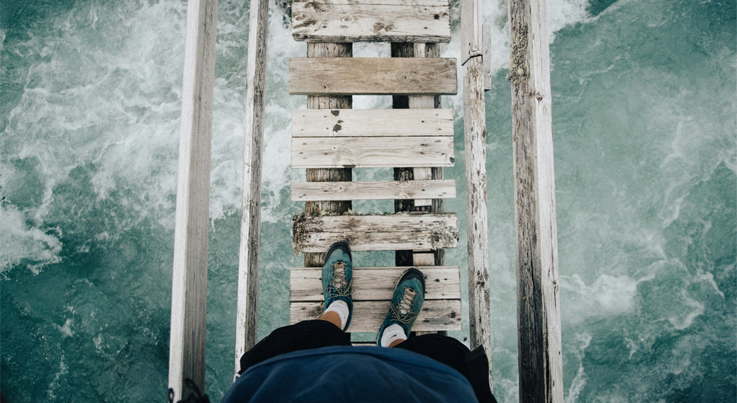 person standing on a wooden bridge