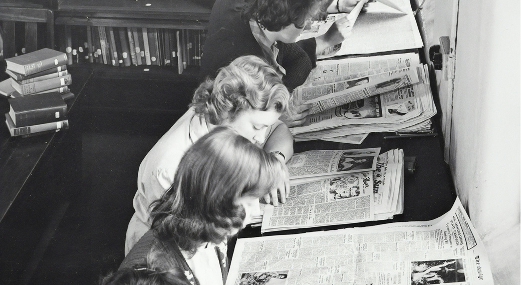 women reading newspapers